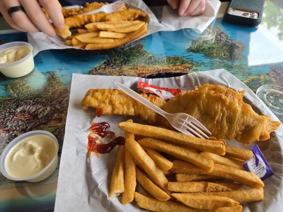 Outdoor seating outside a fish and chips restaurant.